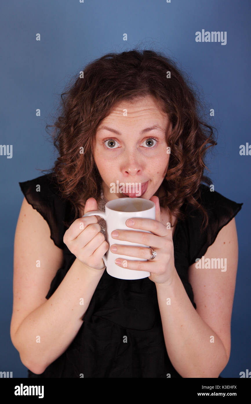 woman tastes morning coffee Stock Photo