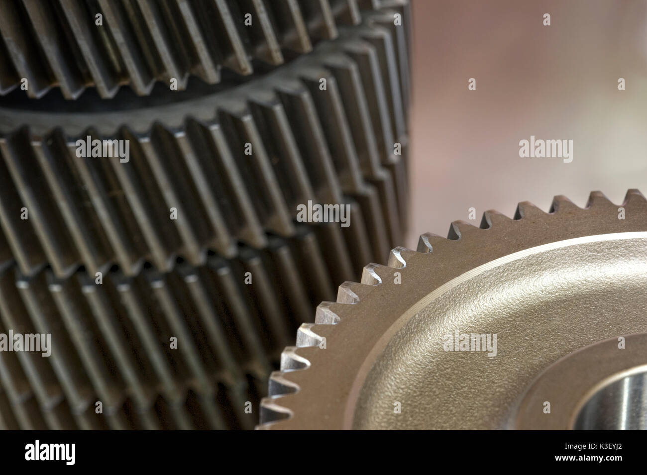 Helical gearing wheels used in manufacturing industrial gear trains for heavy-duty elelctric motors and industrial applications. Stock Photo