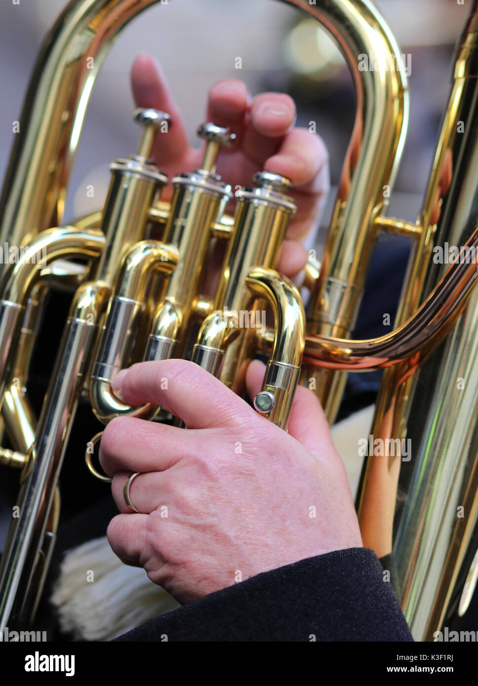 hand of man plays the trombone in the brass band during sound ...