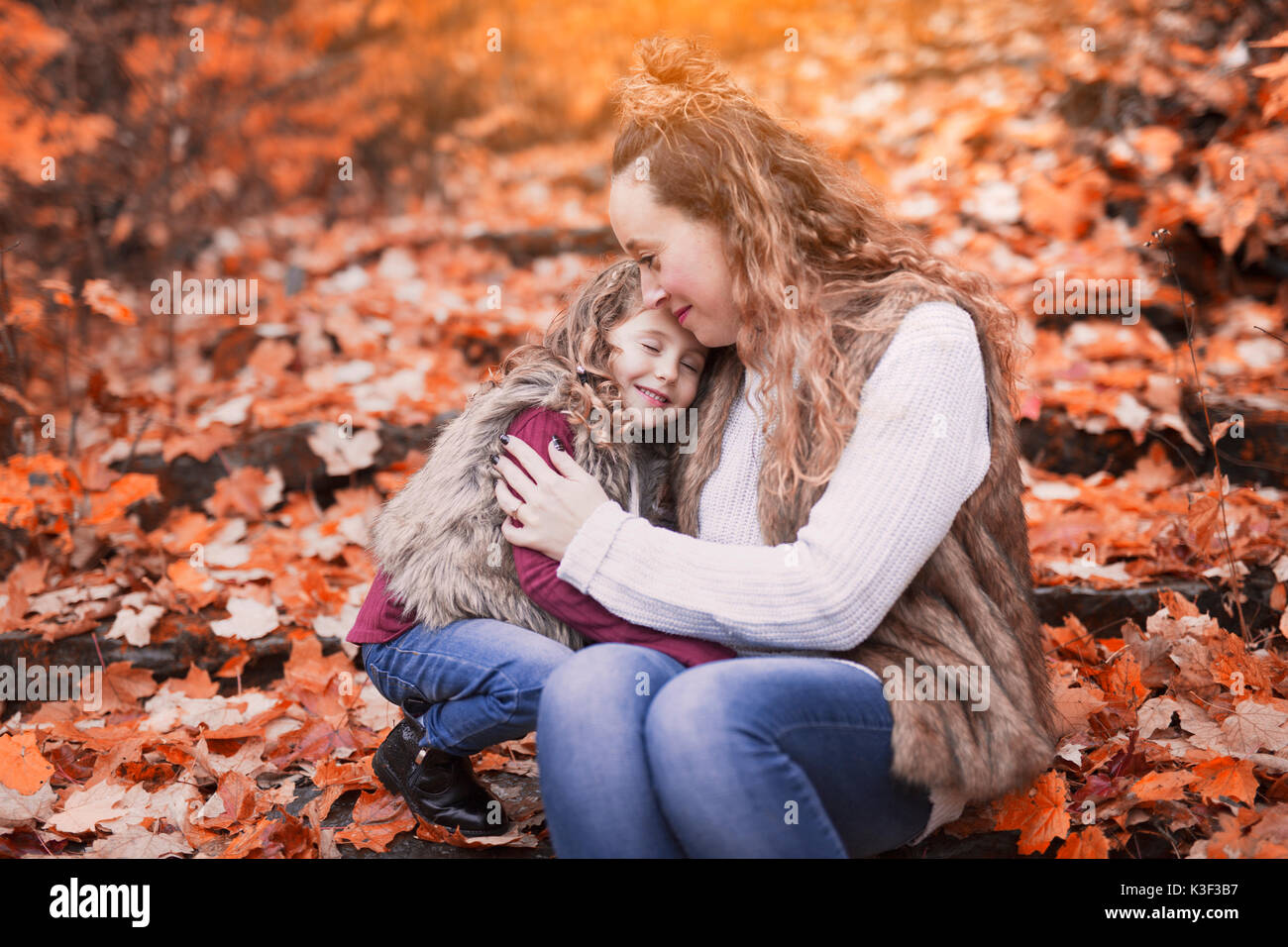Young mother playing with her daughter in autumn park Stock Photo - Alamy