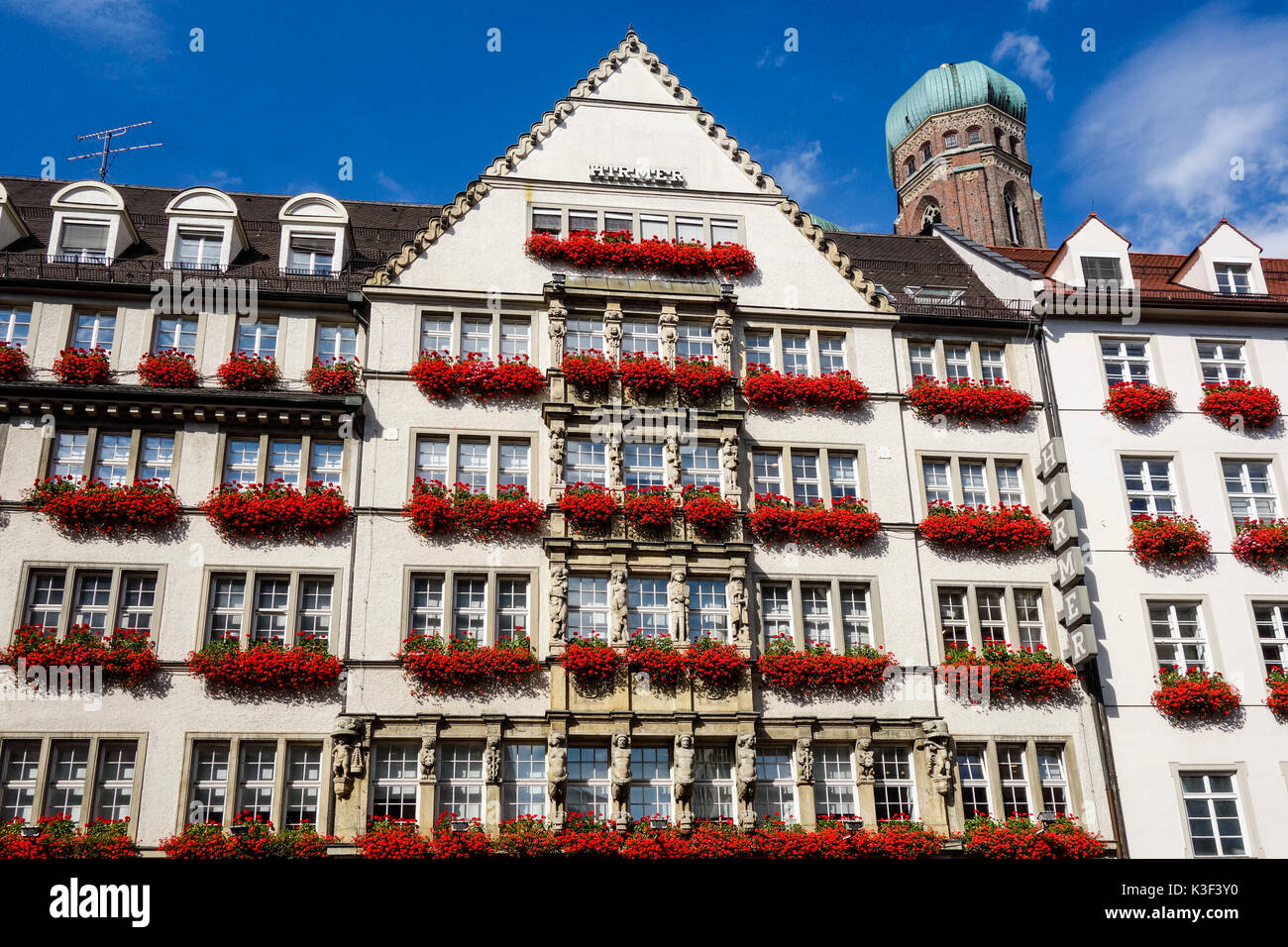 Munich, department store Hirmer in Neuhauserstrasse with Church of Our Lady, Bavaria, Germany