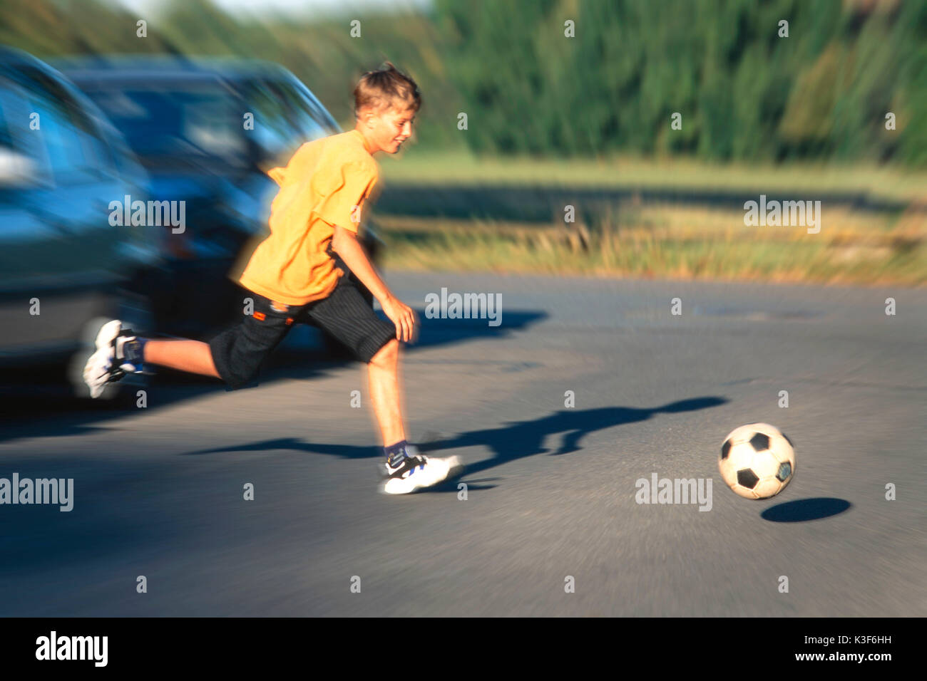 Crossroad Playing. Kids Running with Ball Game on Road Secured