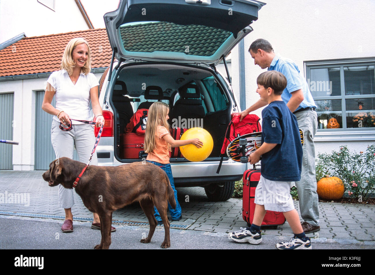 Family while charging the car Stock Photo