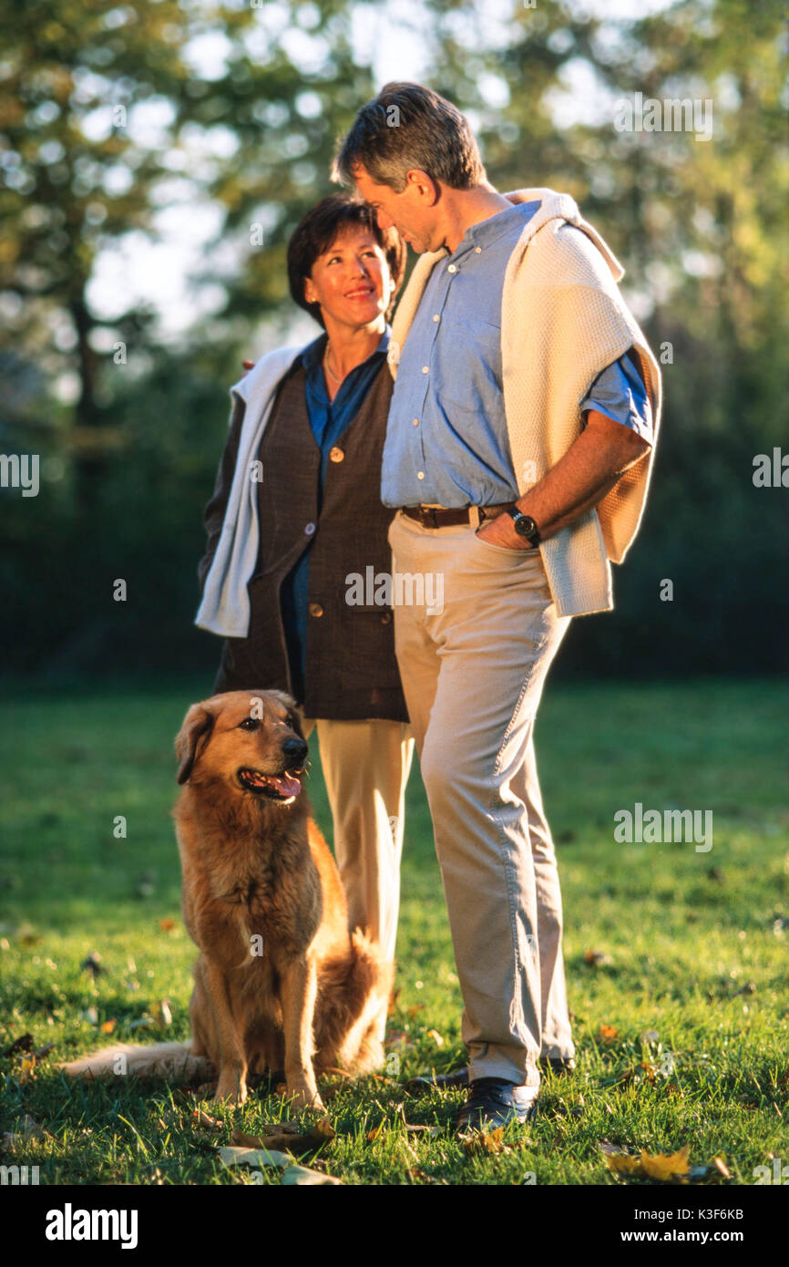 Couple with dog at the park Stock Photo