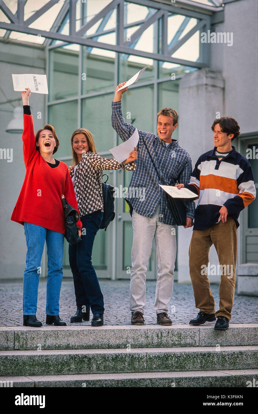Schoolboys hold up her high school diplomas Stock Photo