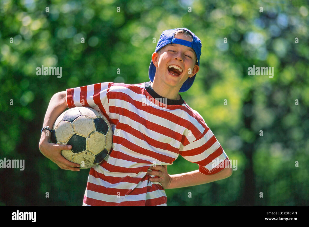 boy with football under the arm Stock Photo