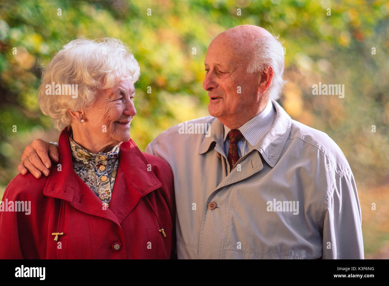 Old married couple has a look, man places his arm around the woman Stock Photo