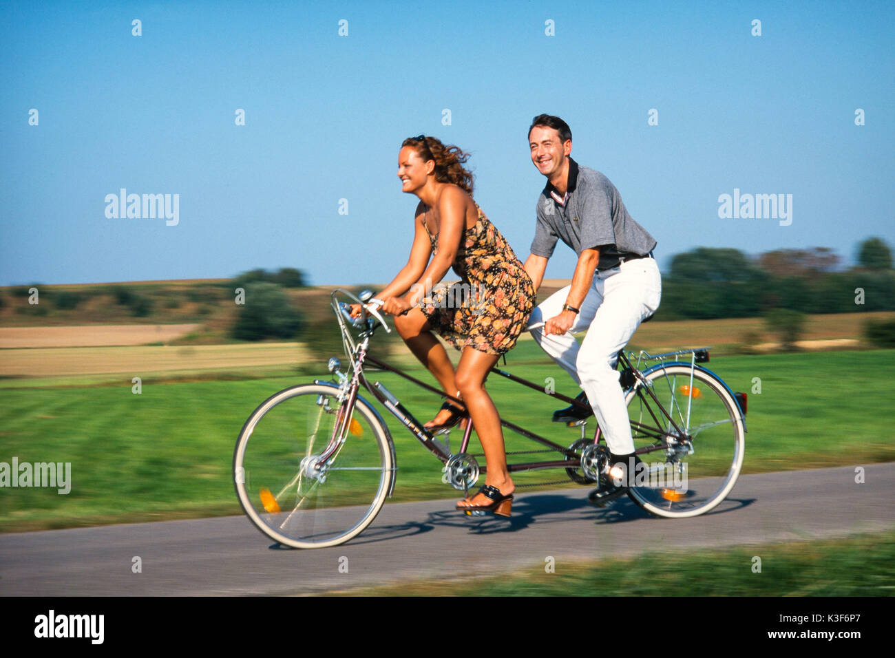 Tandem bike couple hi-res stock photography and images - Alamy