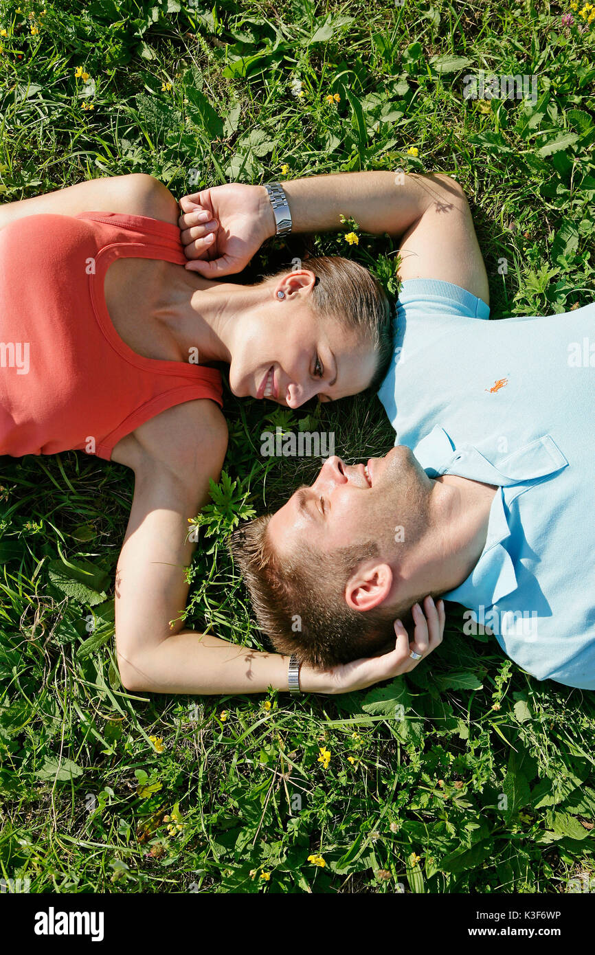 Young couple lies in a meadow Stock Photo