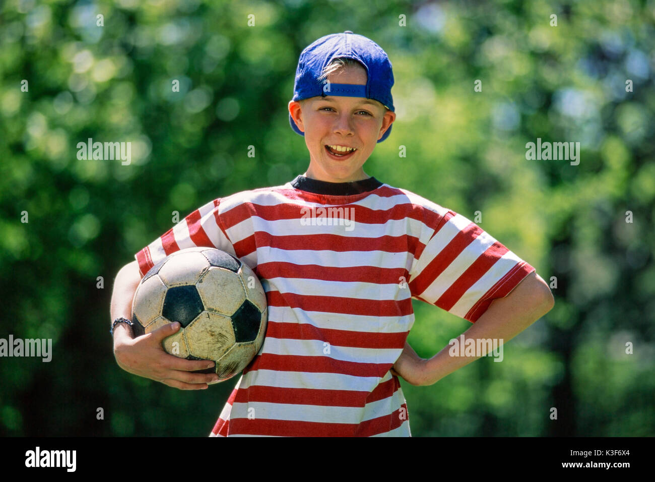 Boy carries football under the arm Stock Photo
