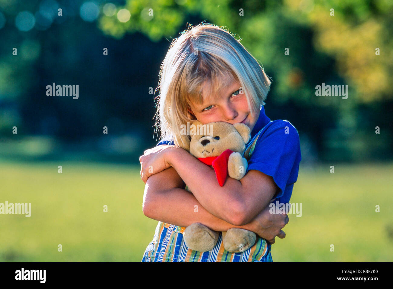 Child with teddy bear hi-res stock photography and images - Alamy
