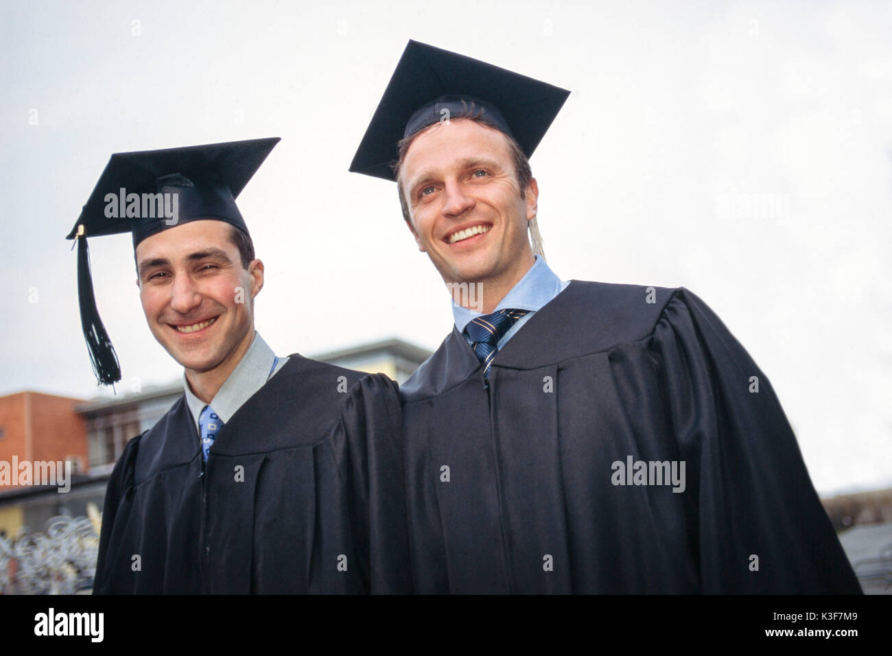 Two university graduates with doctoral caps Stock Photo
