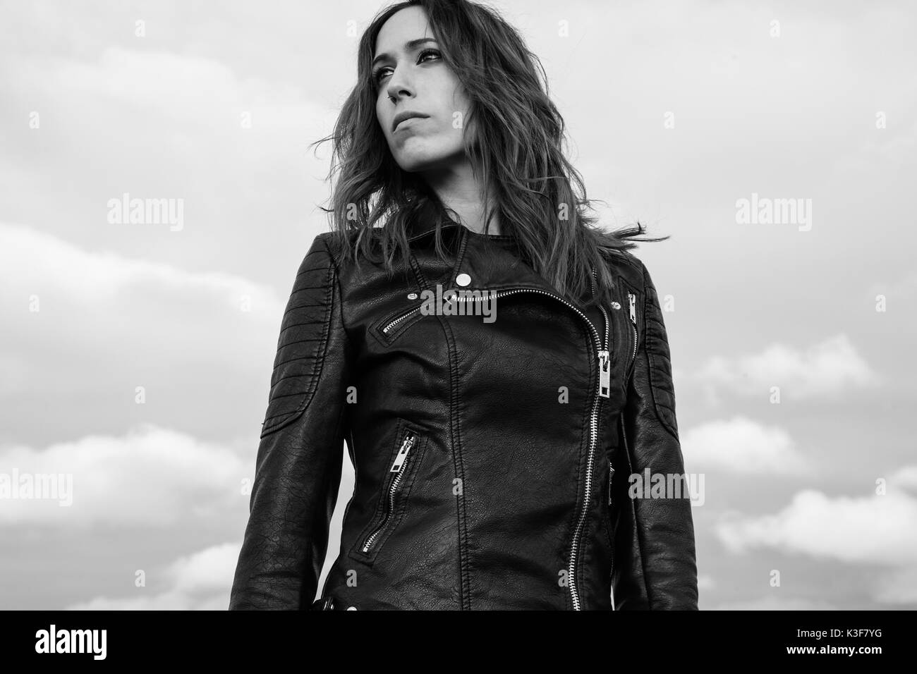 Waist-Up Portrait of Young Adult Woman in Black Leather Jacket Stock Photo