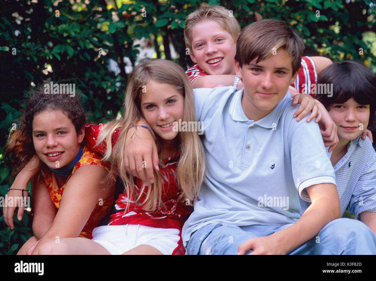 Group of laughing children / of young persons Stock Photo