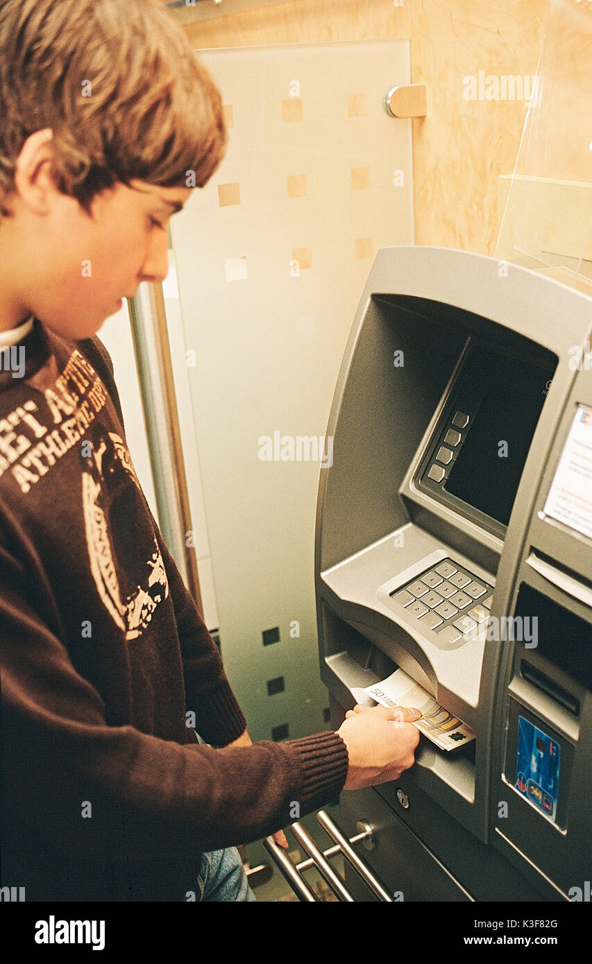 Young person gets at the bancomat money Stock Photo