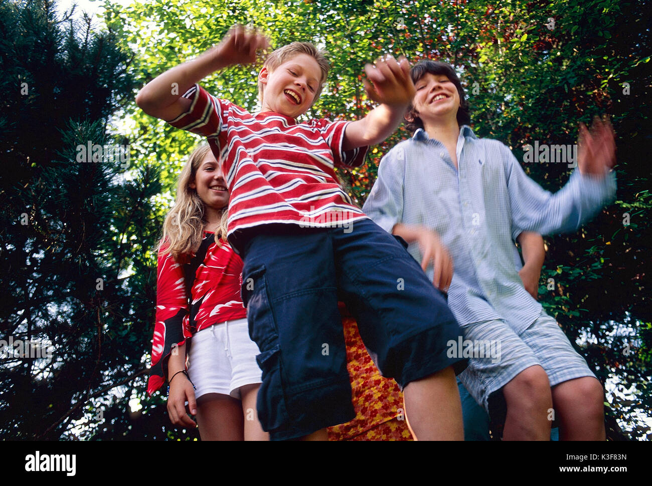 Group of laughing children / of young persons from the below shot Stock Photo