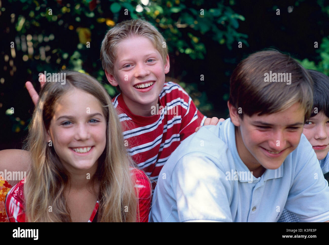 Group of laughing children / of young persons Stock Photo
