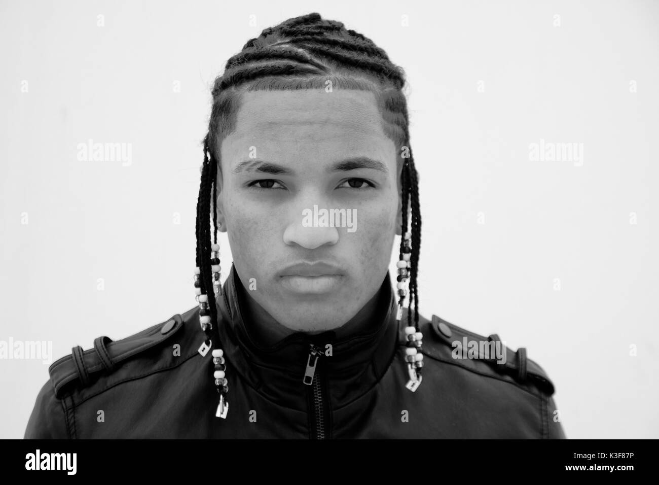 Portrait of Young Adult Man with Braided Hair Stock Photo