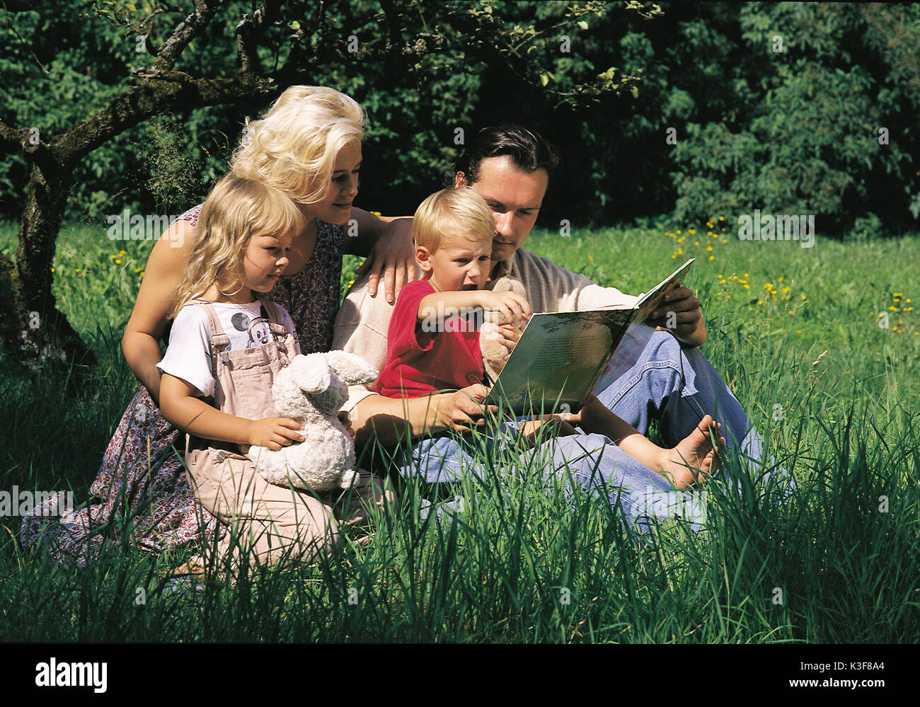 Young family on meadow Stock Photo