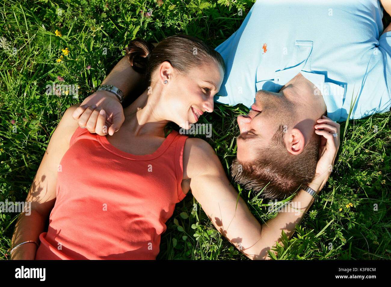 Young couple lies in a meadow Stock Photo