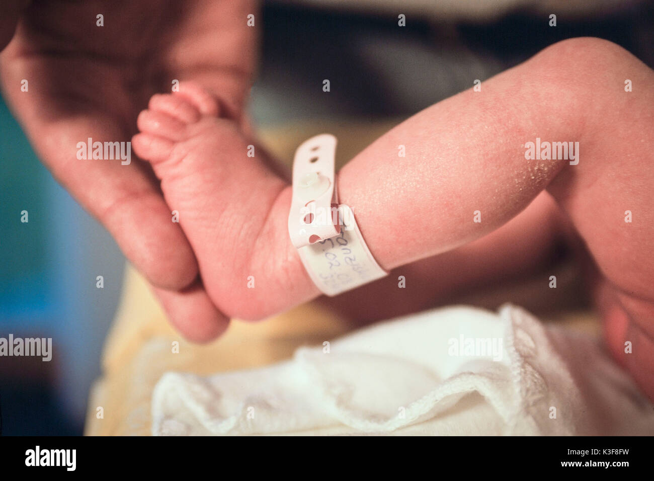 Foot of a newborn child with badge Stock Photo