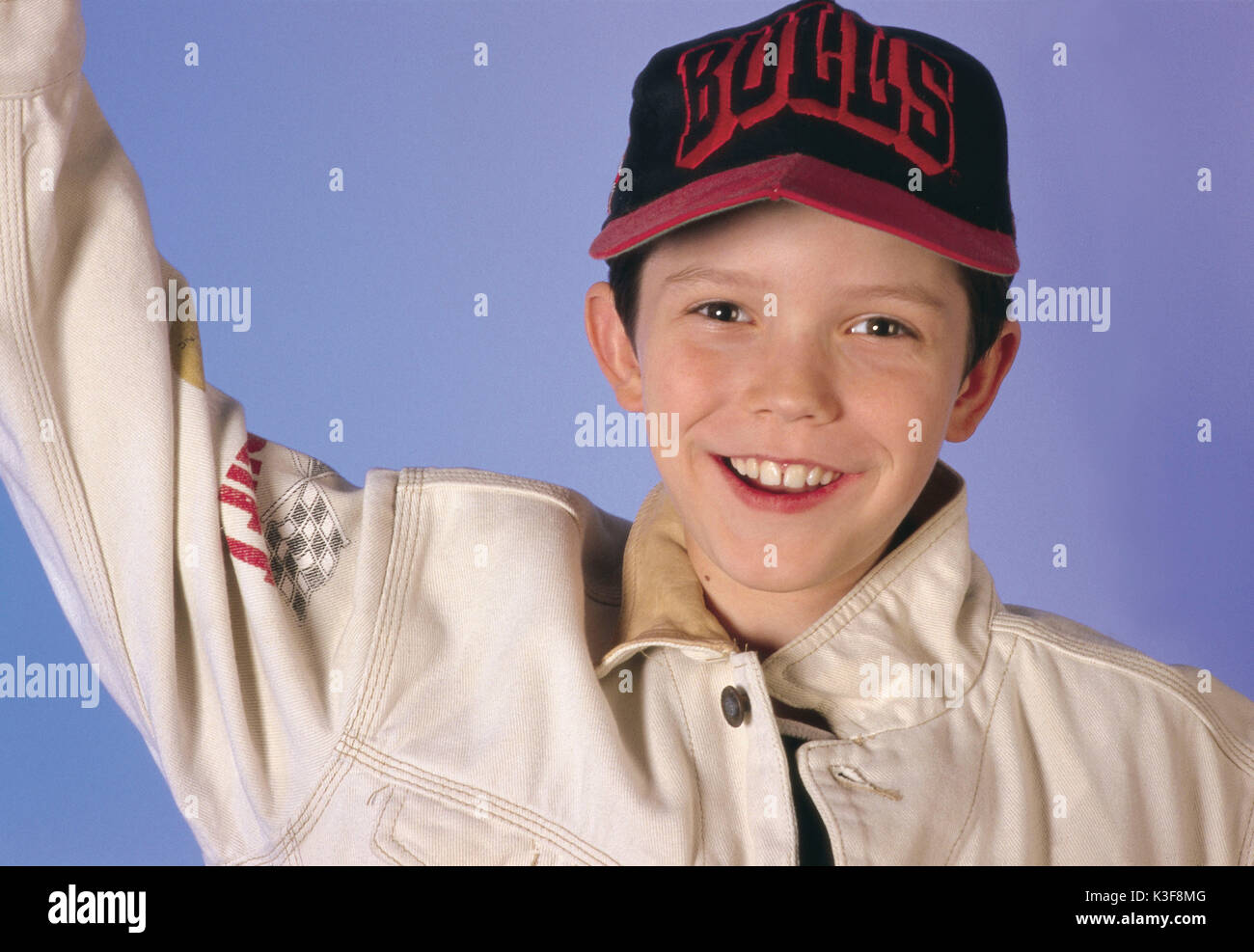 Boy rejoices, is pleased, laughs, pulls an arm upwards Stock Photo