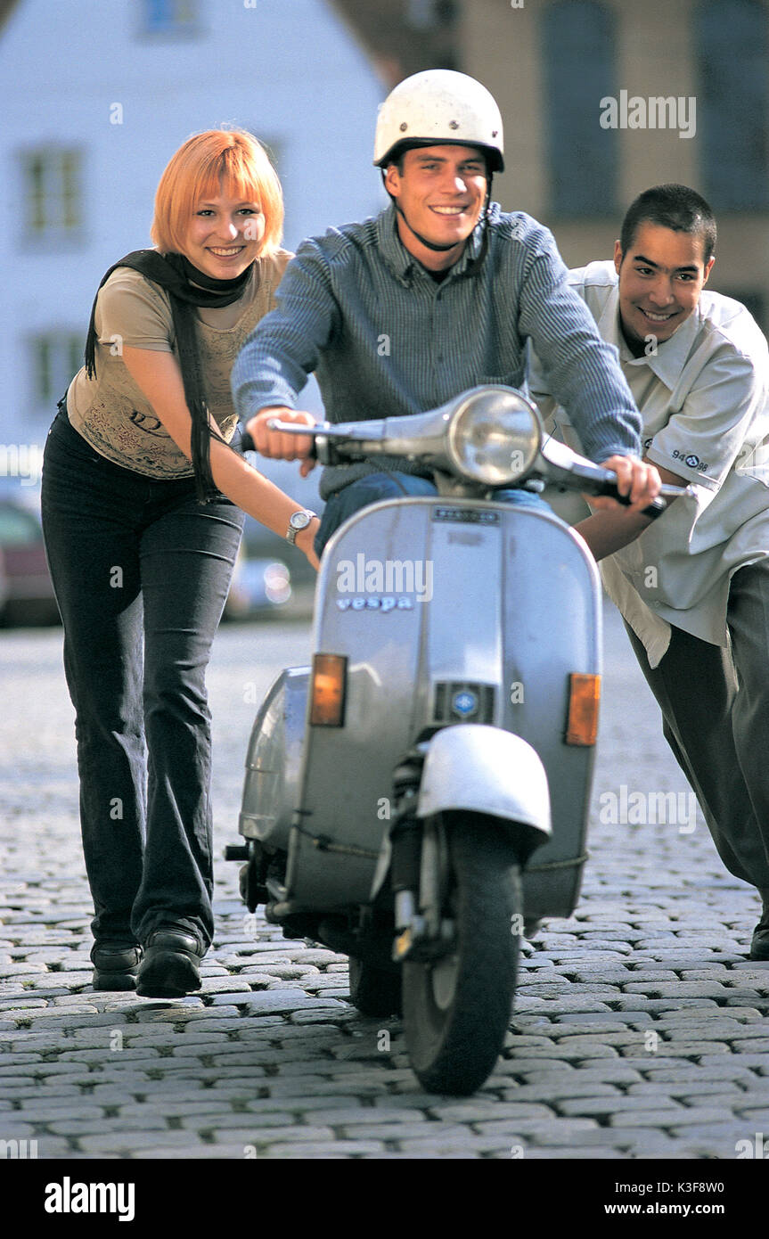Young person by Vespa scooter Stock Photo