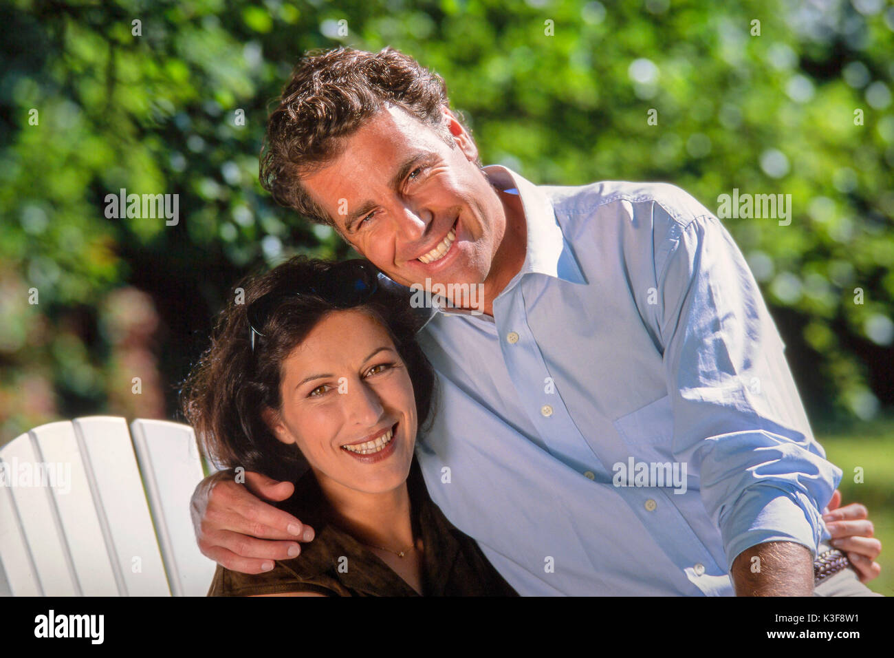 Couple in the garden, arms around each other Stock Photo
