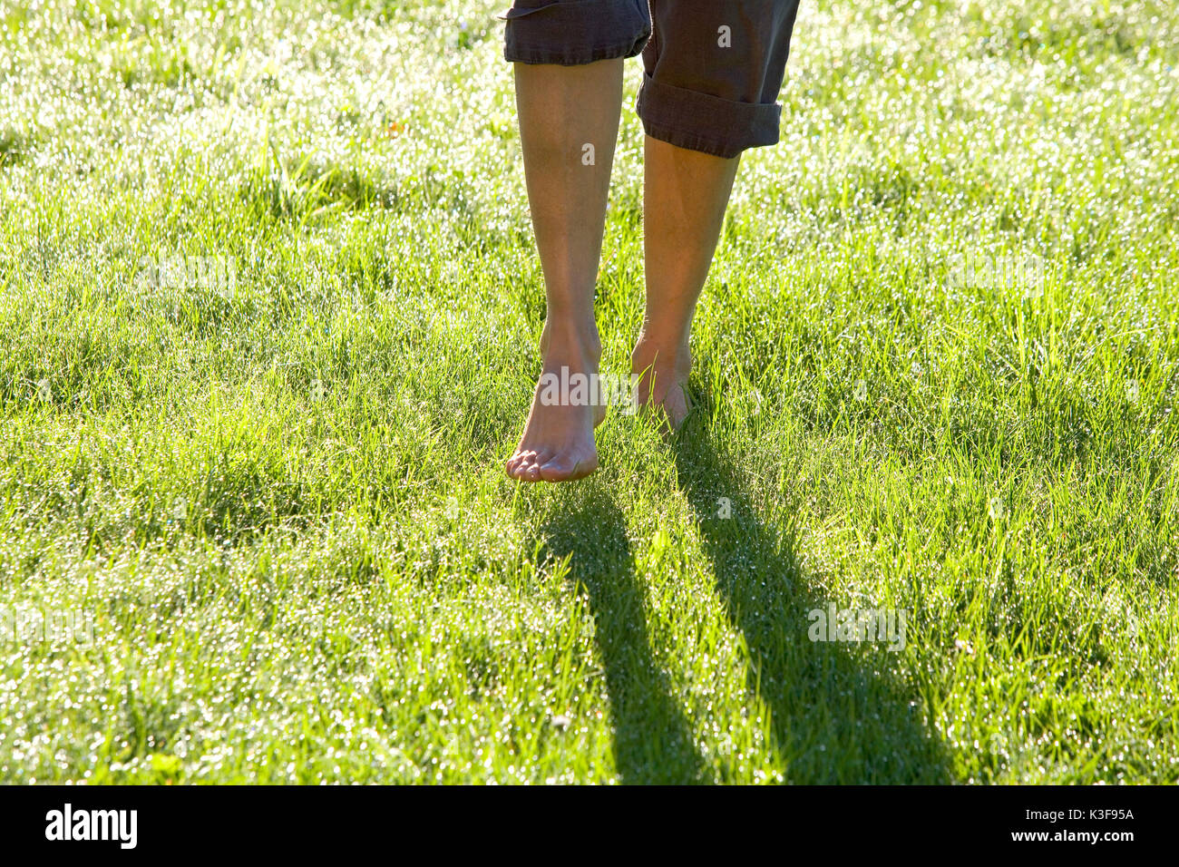 Barefooted walking on a meadow with  morning rope Stock Photo