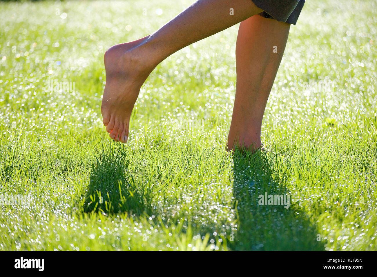 Barefooted walking on a meadow with  morning rope Stock Photo