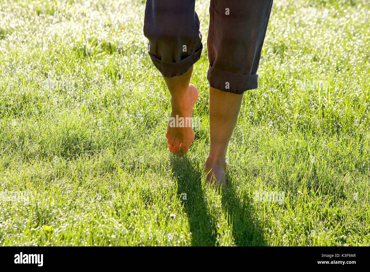 Woman walking barefoot grass garden hi-res stock photography and images ...