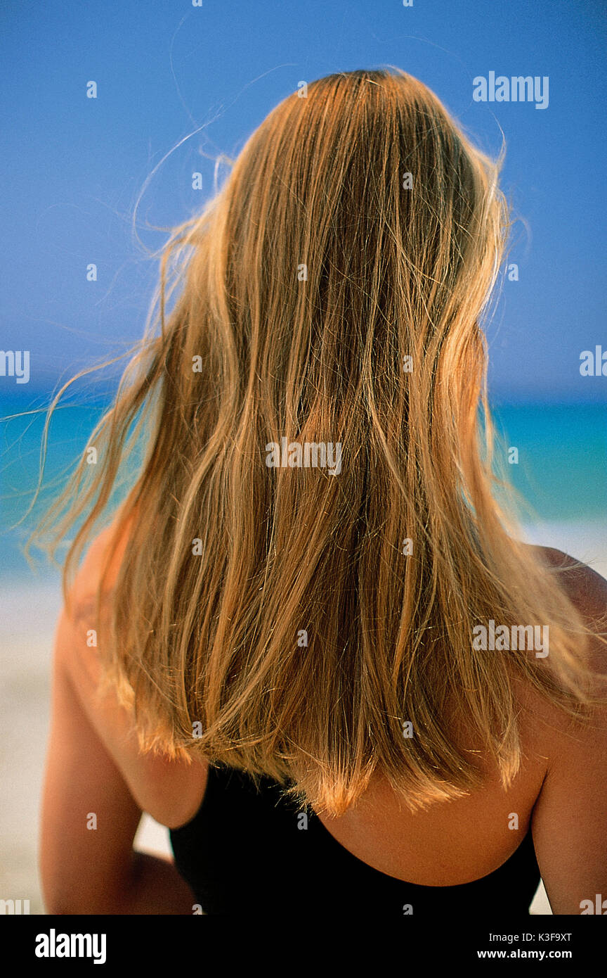 Long-haired blond woman from the back Stock Photo