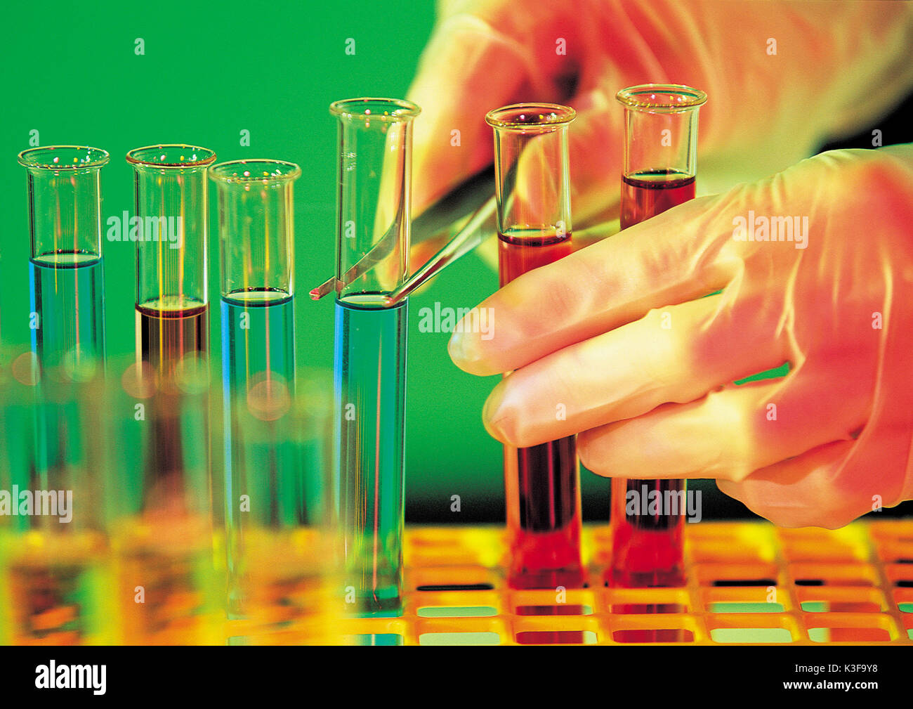 Tweezers at the test tube, laboratory Stock Photo
