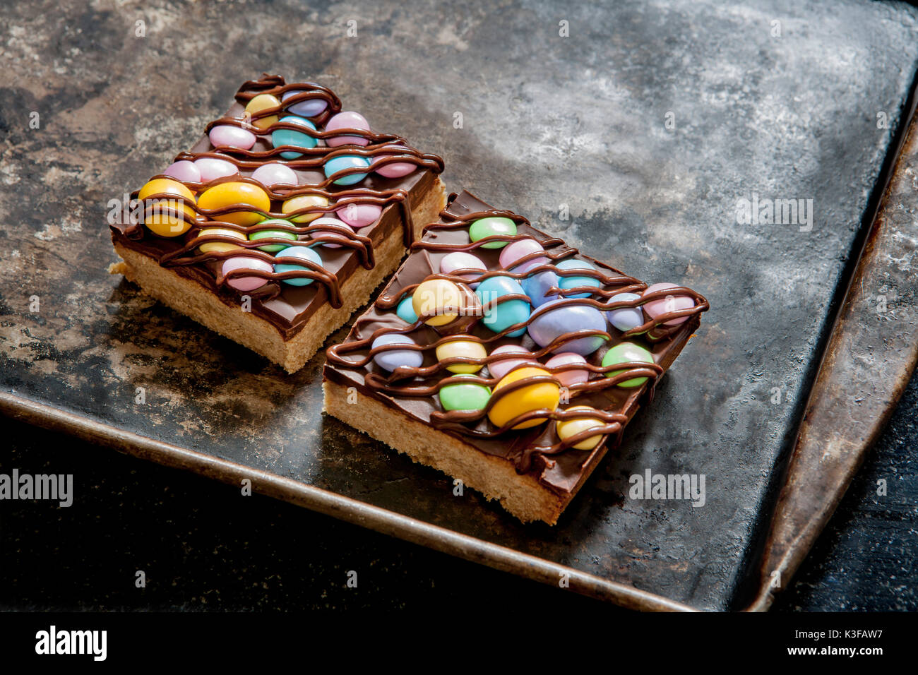Colorful Shortbread Candy Bars Drizzled with Chocolate on Baking Sheet Stock Photo