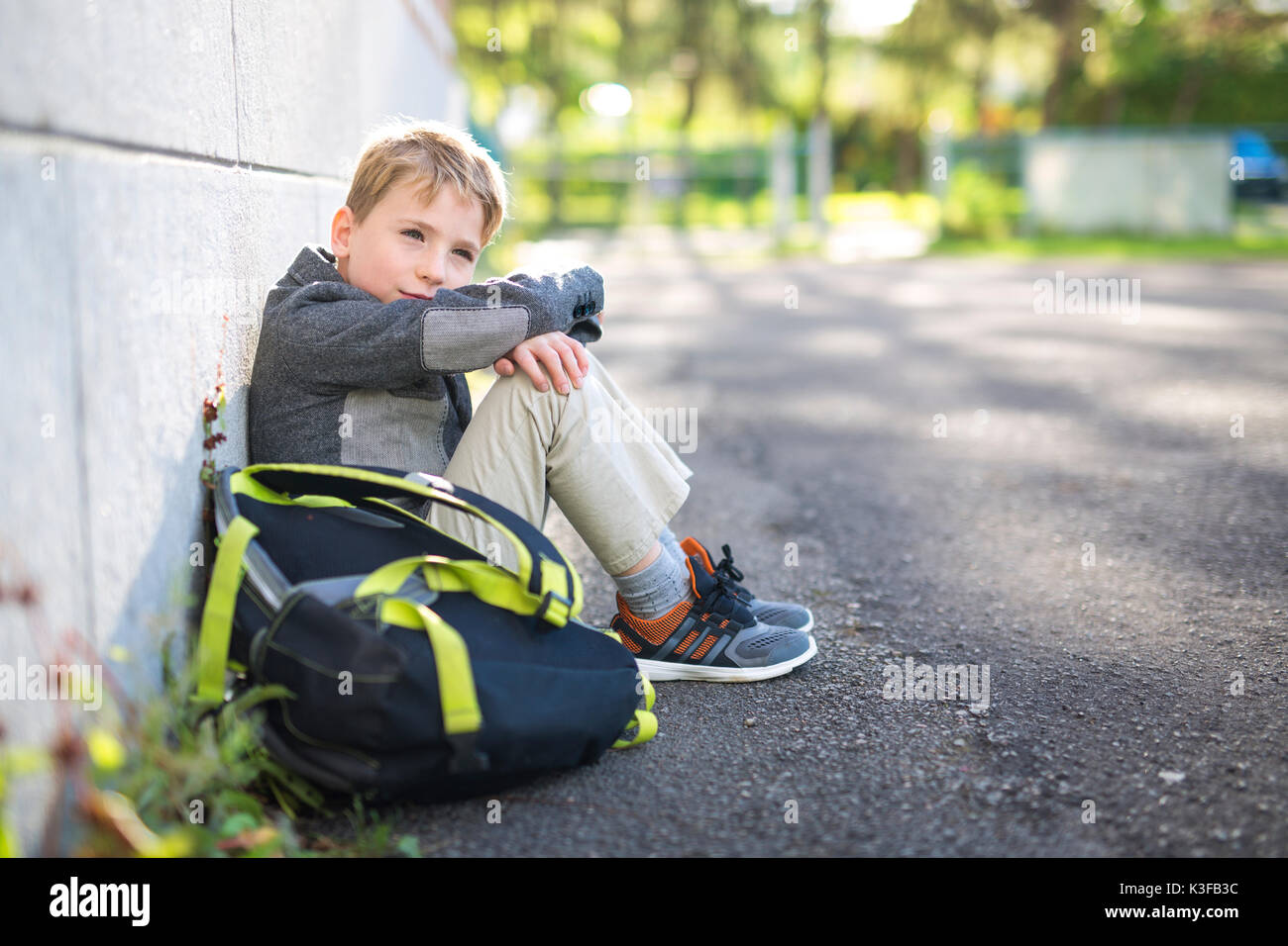 student boy outside at school standing Stock Photo - Alamy