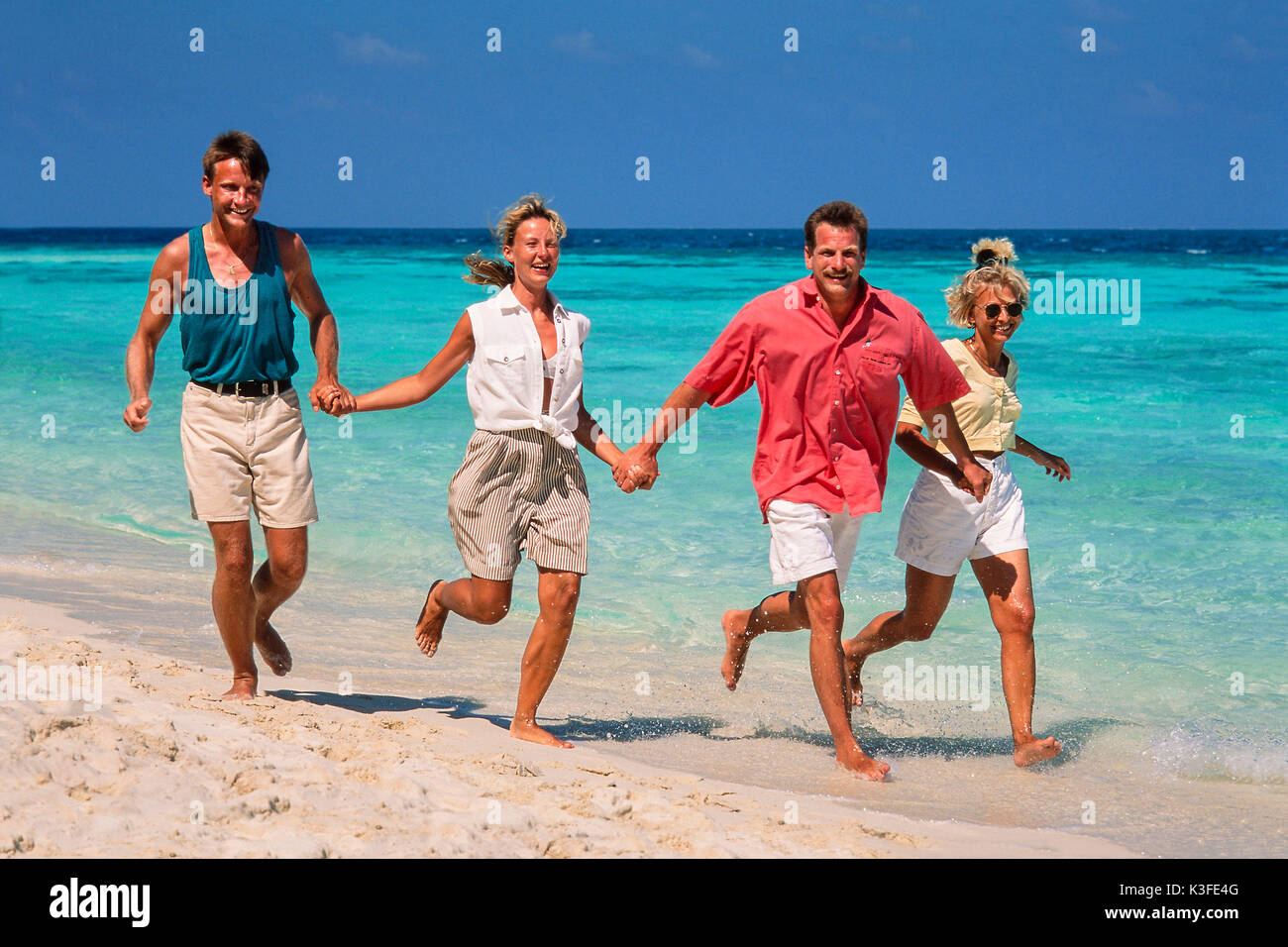 Two couples close the beach walk Stock Photo