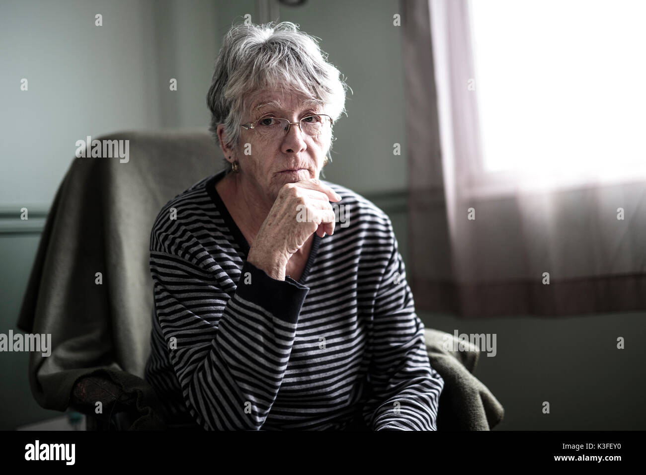 worried senior woman at home felling very bad Stock Photo