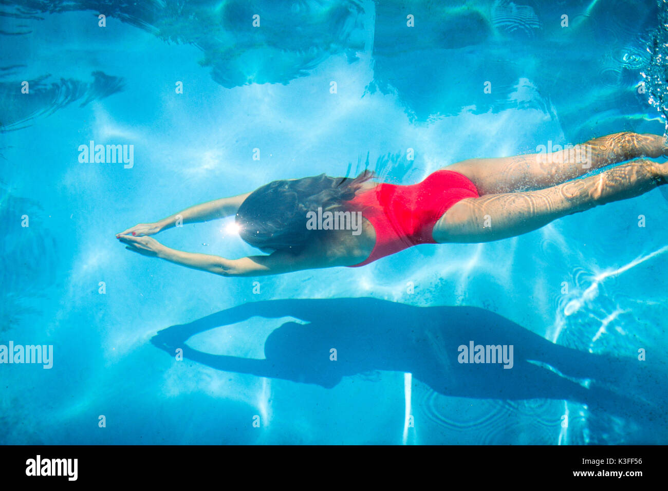 woman dives in swimming-pool Stock Photo