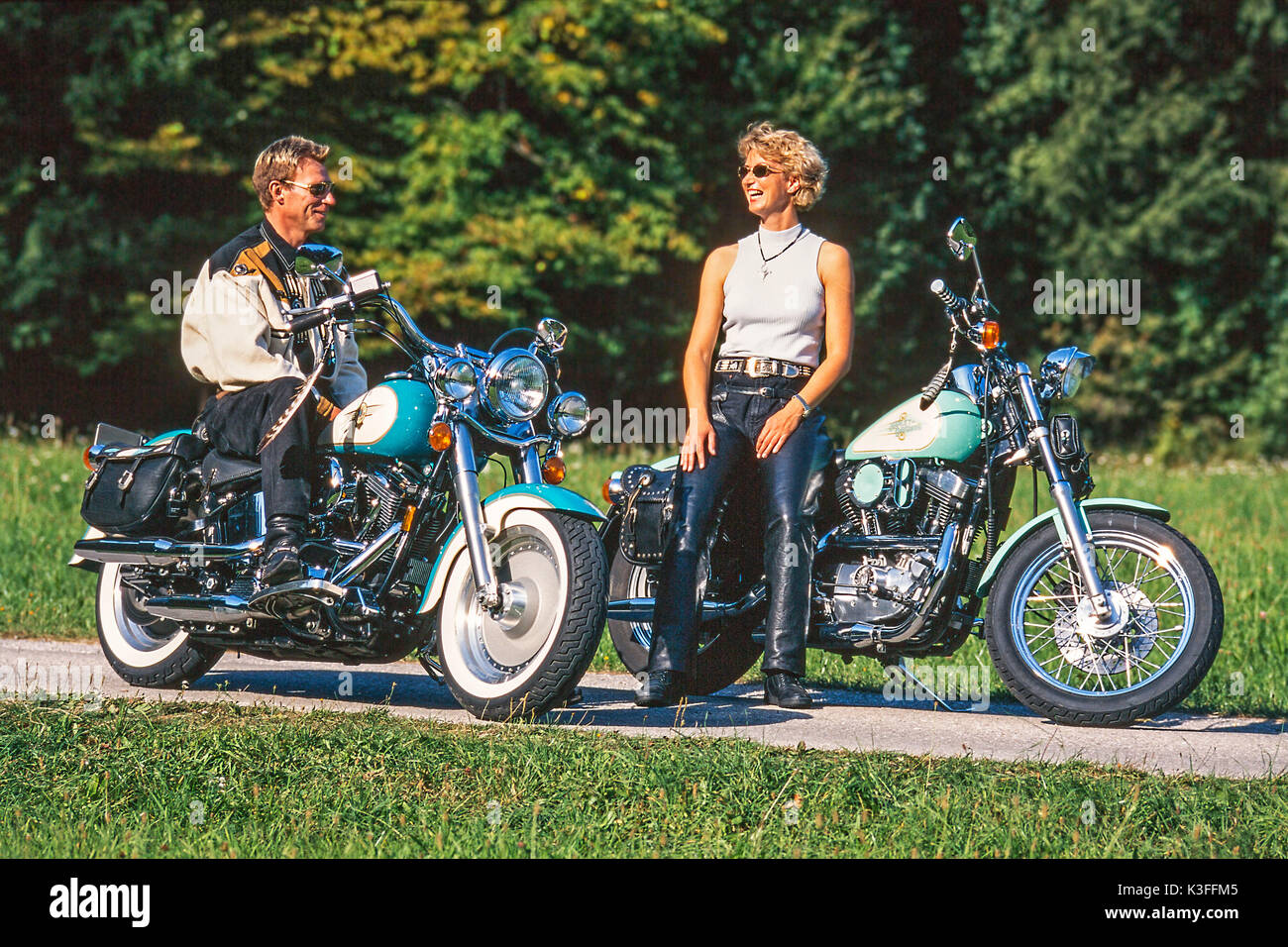 Couple by Harley Davidson motorcycles Stock Photo