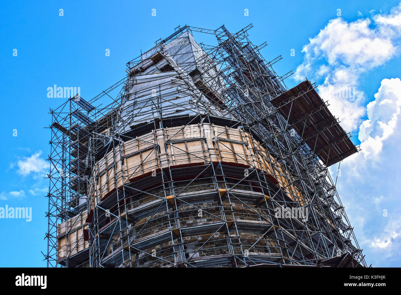 Construction, building, reparation, restoration, renovation, insulation of a large building framed by scaffoldings. Stock Photo