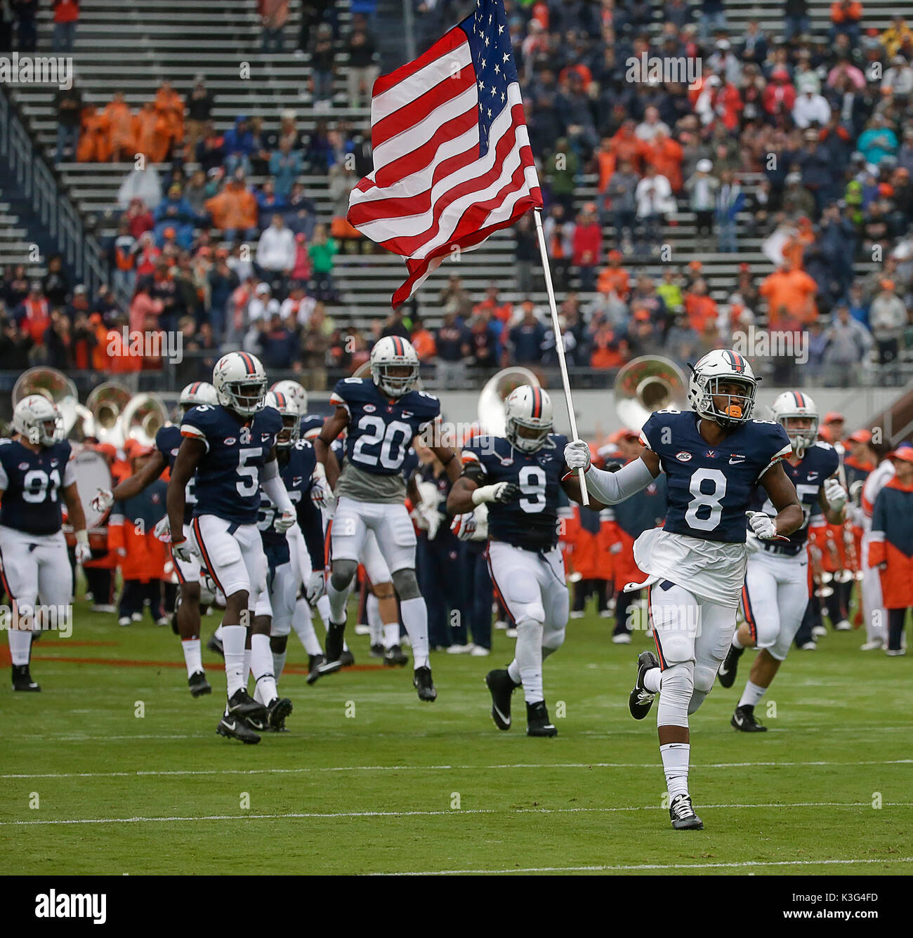 Charlottesville, Virginia, USA. 2nd Sep, 2017. University of Virginia Cavalier WR #8 Hasise Dubois leads his teammates onto the field with the American flag during NCAA football game between the University of Virginia Cavaliers and the William & Mary Tribe at Scott Stadium in Charlottesville, Virginia. Justin Cooper/CSM/Alamy Live News Stock Photo