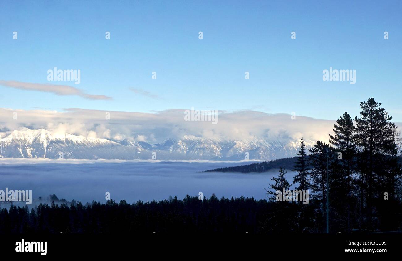 Fog shrouded valley in the mountains in winter Stock Photo