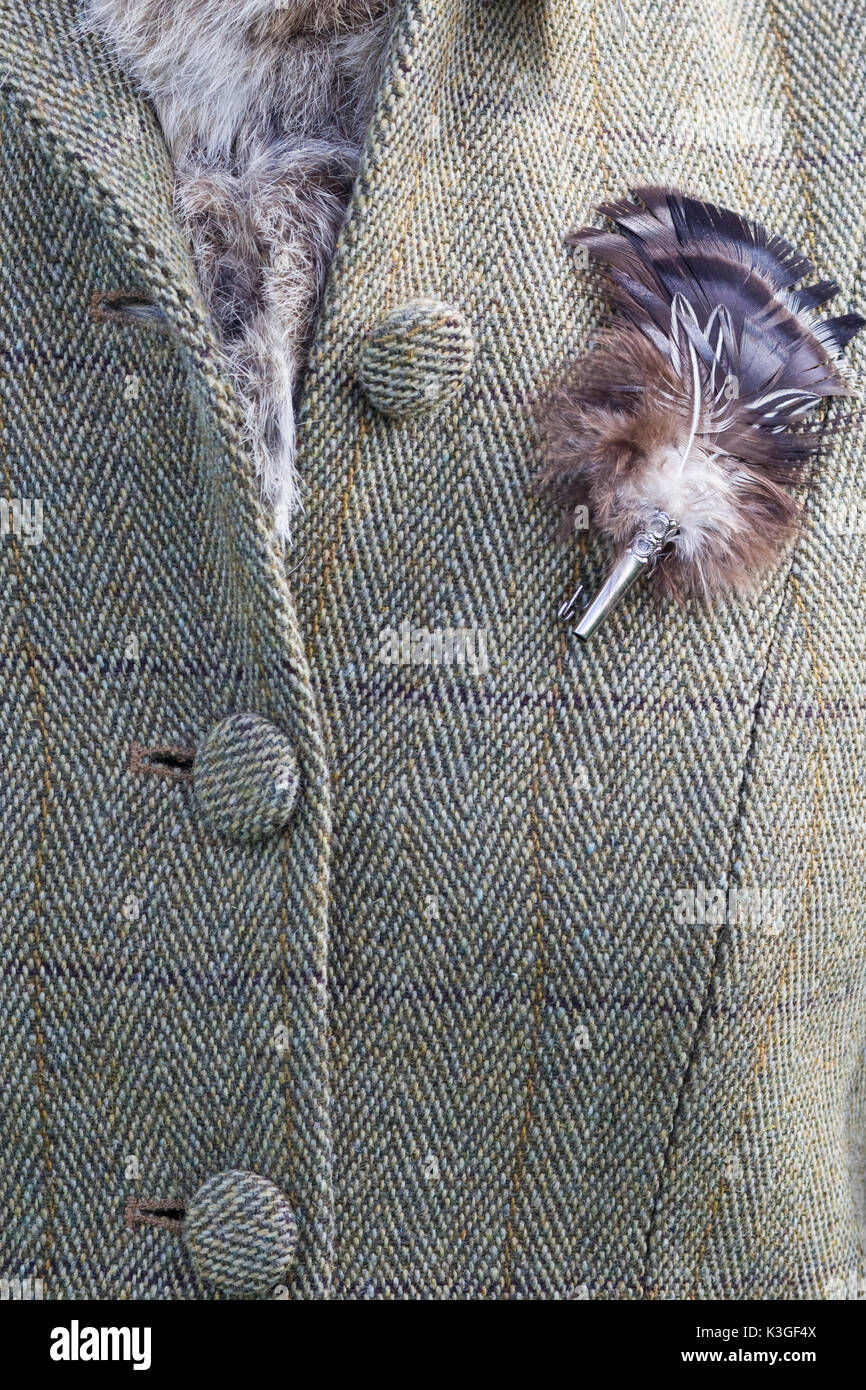 Tweed riding jacket with feather brooch Stock Photo