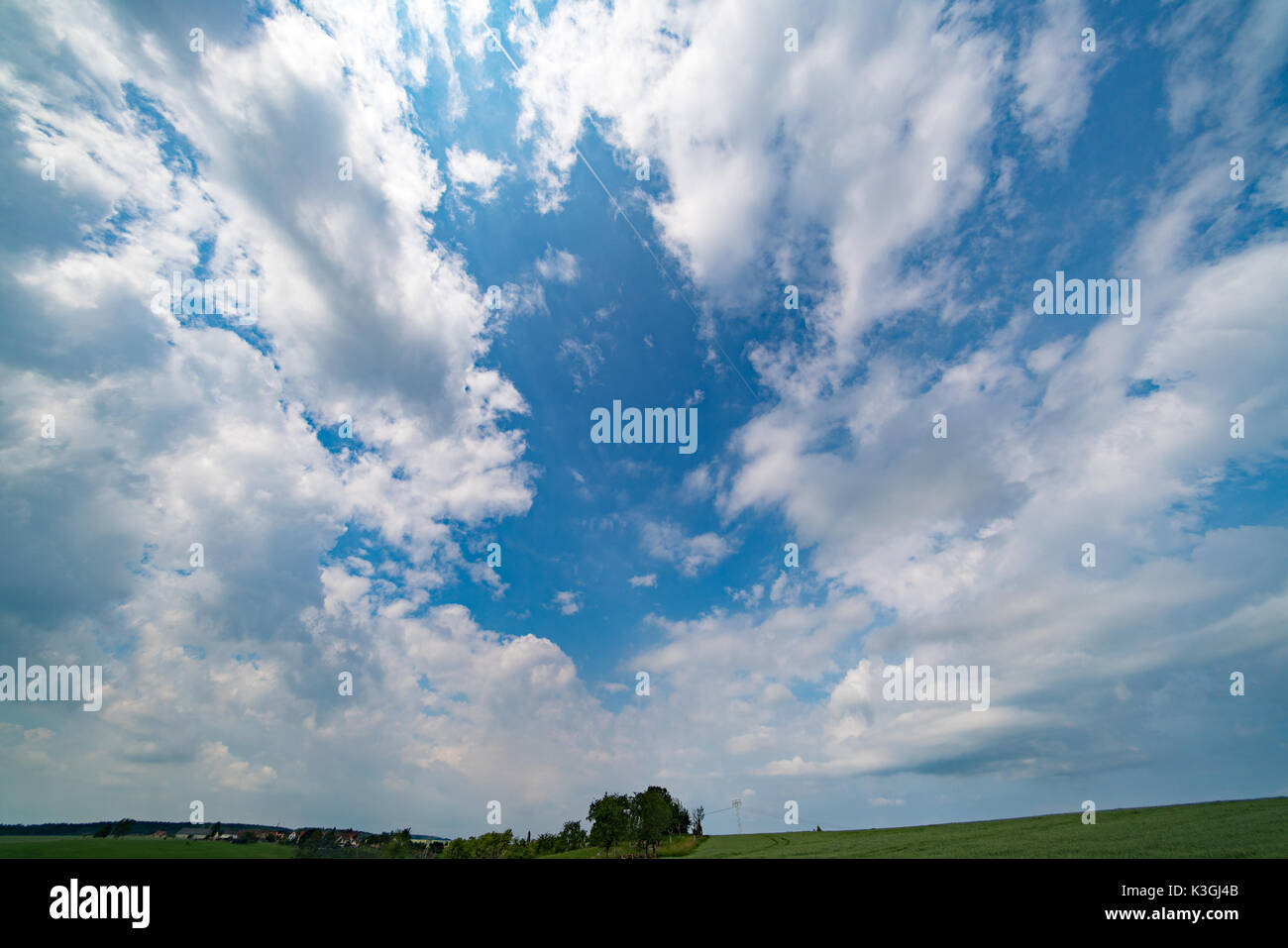 Green field and clear cloudy sky Stock Photo - Alamy