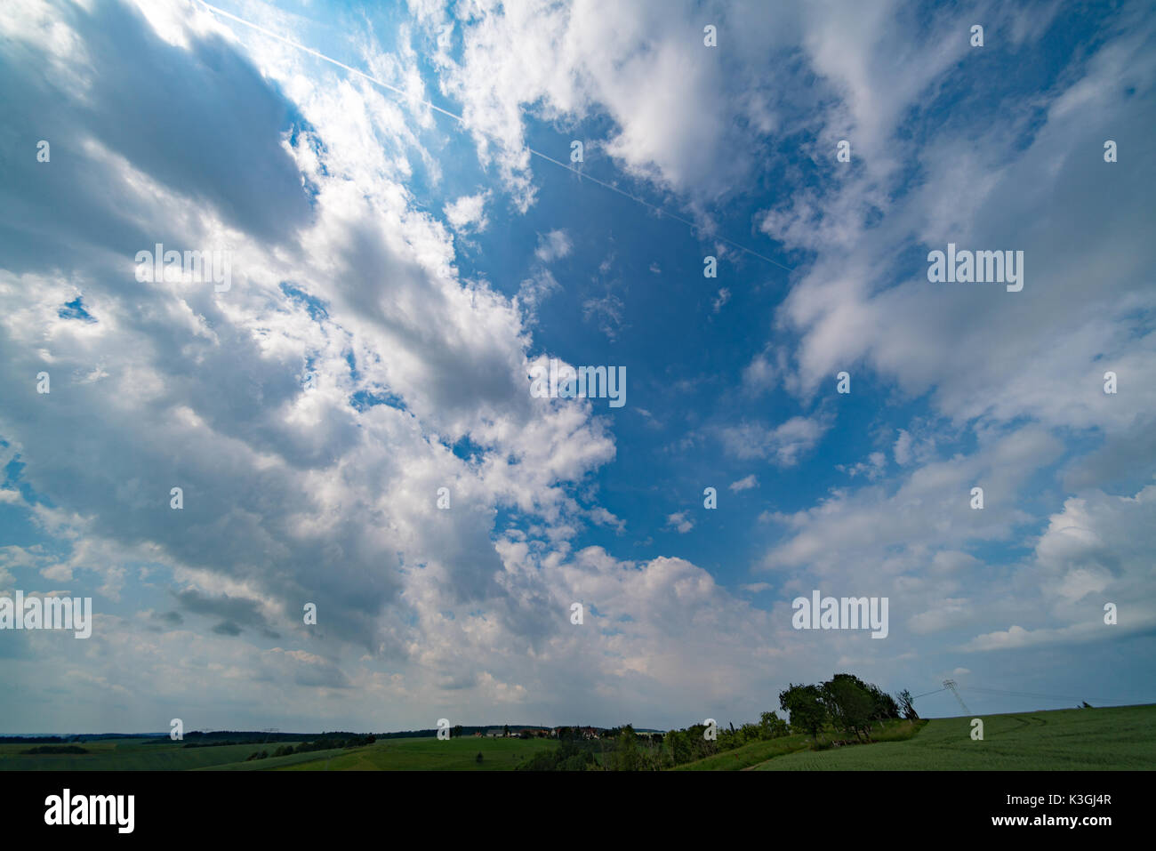 Green field and clear cloudy sky Stock Photo - Alamy