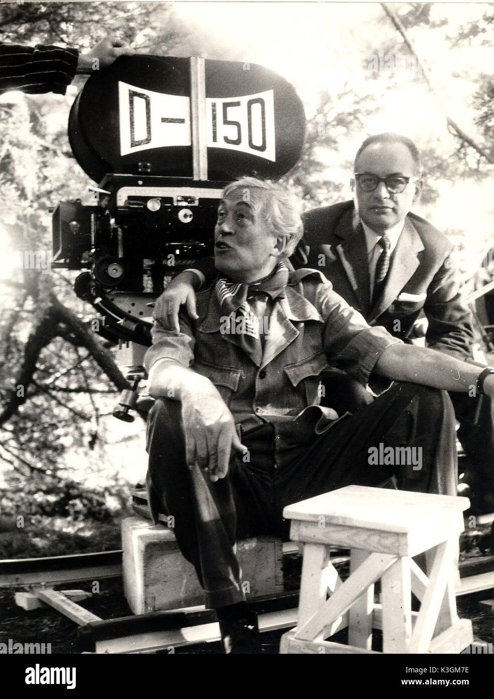 Director JOHN HUSTON and producer DINO DE LAURENTIIS in front of the D-150 camera between takes of THE BIBLE . This was the first film shot in the D-150 wide film process. THE BIBLE [US / IT 1966] Director JOHN HUSTON [centre] and Producer DINO DE LAURENTIIS in front of the D-150 camera between takes. This was the first film shot in the D-150 wide film process. Stock Photo