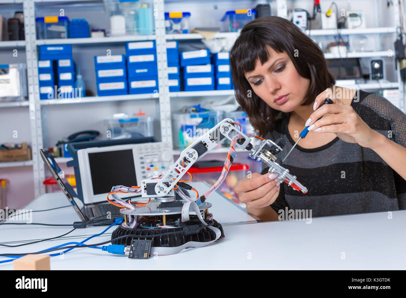 Female in robotics laboratory. Young woman experiment with robot Stock  Photo - Alamy