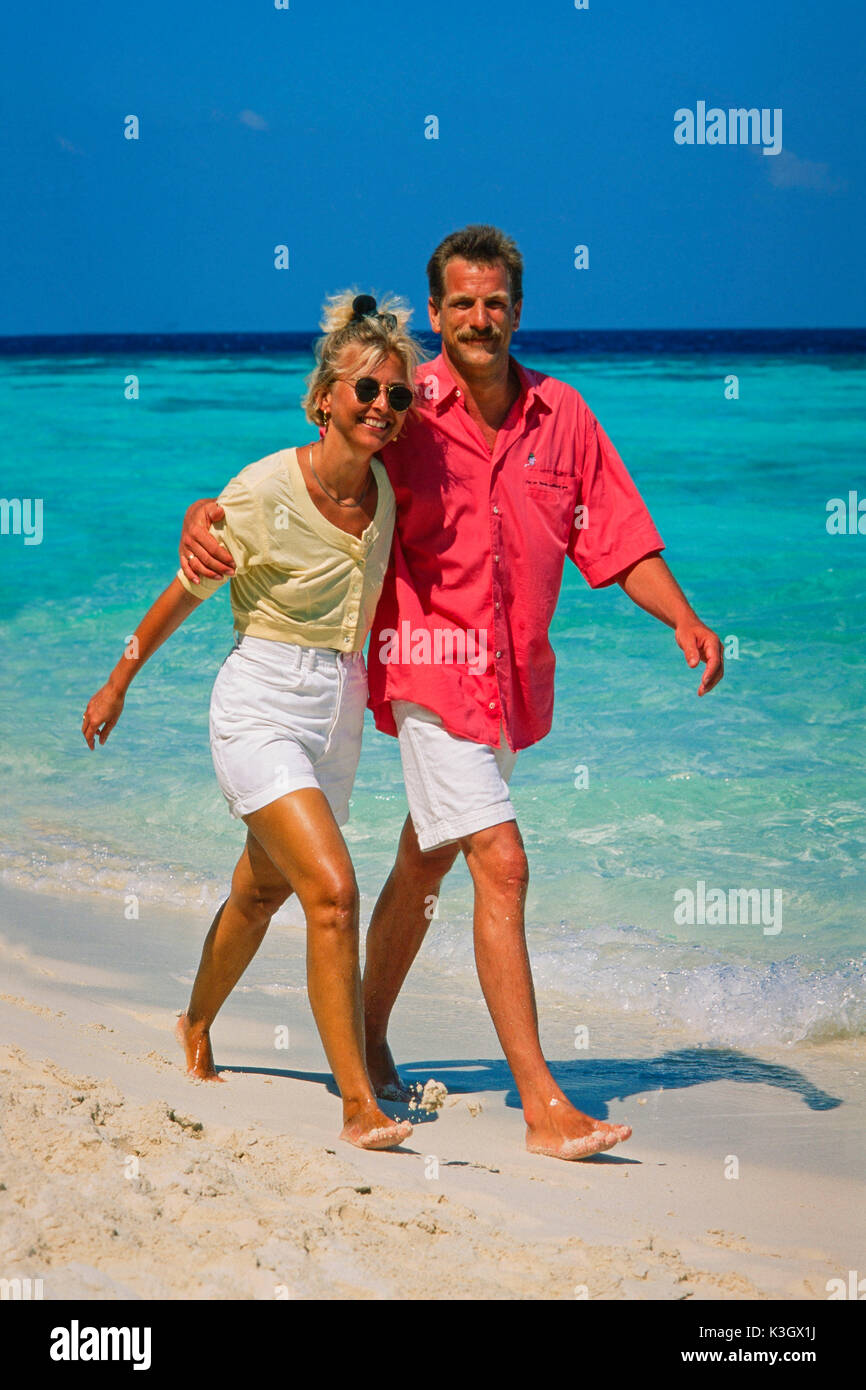 A pair goes for a walk at the beach (the Maldives) Stock Photo