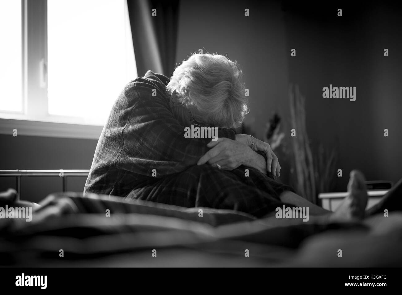 tired senior woman on her bed Stock Photo