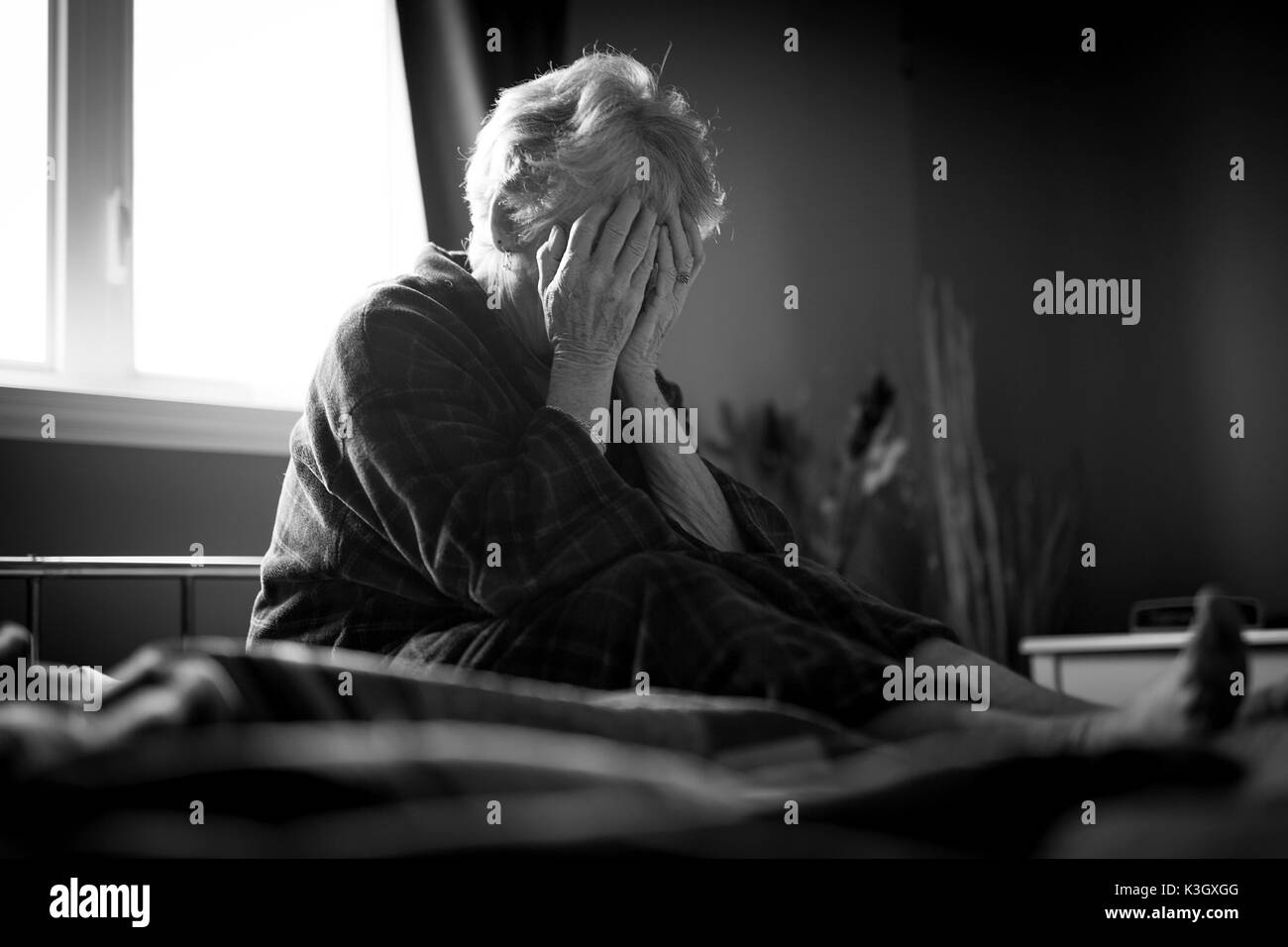 tired senior woman on her bed Stock Photo